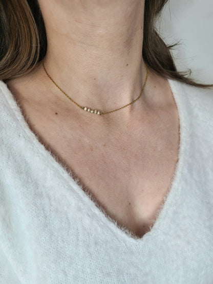 Élégance est un collier en acier inoxydable doré composé de véritable pierres naturelles.